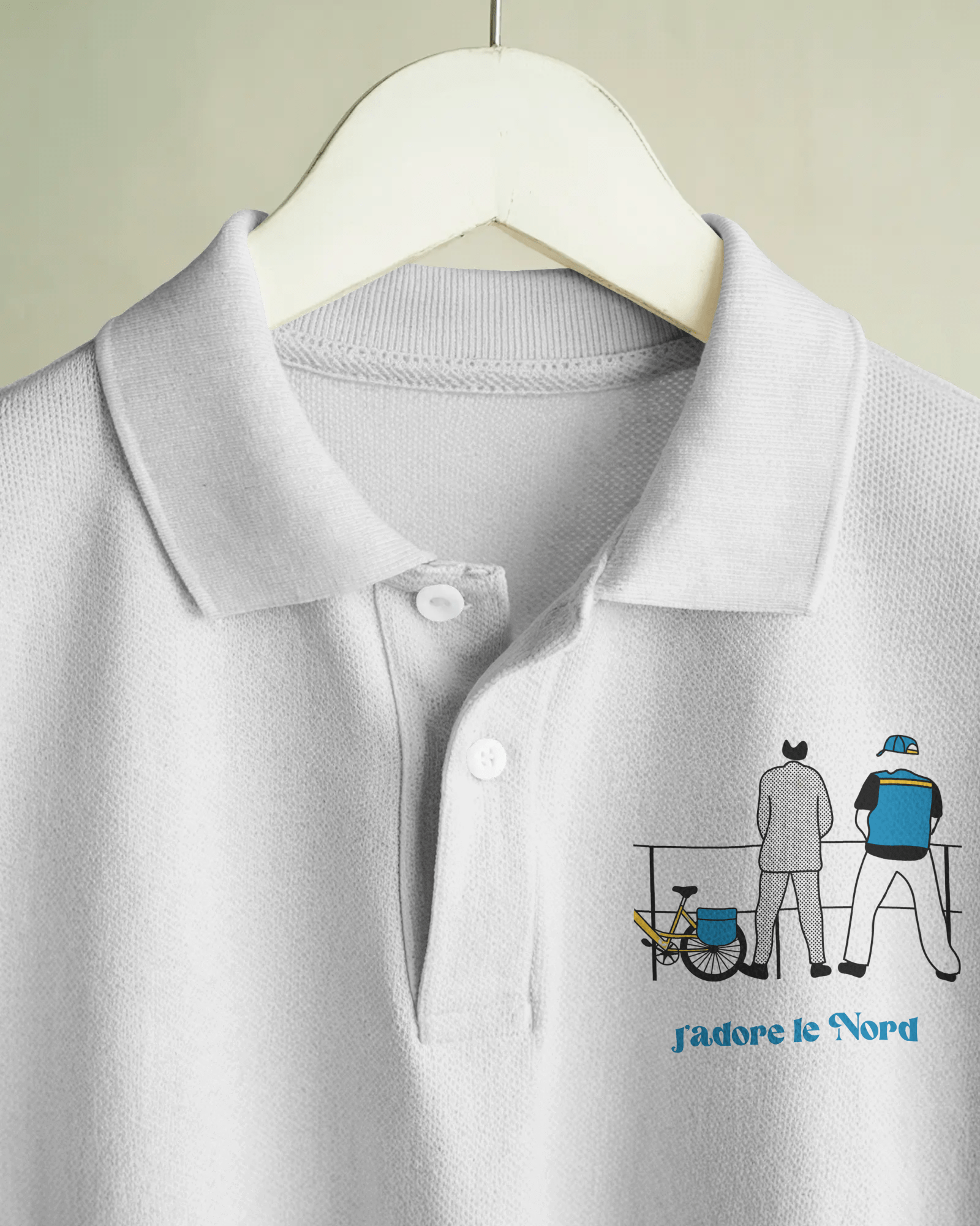 White MerciSidi polo featuring embroidered "Bienvenue chez les ch'tis" design, showcasing a casual look.